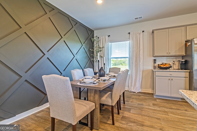 dining space featuring light hardwood / wood-style flooring