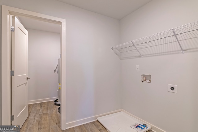 washroom featuring hookup for a washing machine, hardwood / wood-style floors, electric water heater, and electric dryer hookup