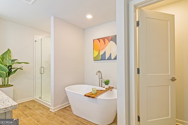 bathroom featuring vanity, shower with separate bathtub, and wood-type flooring