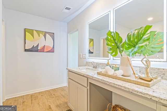 bathroom featuring vanity and wood-type flooring