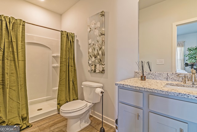 bathroom with vanity, hardwood / wood-style floors, toilet, and walk in shower