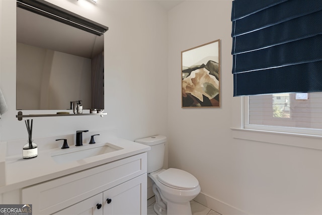 bathroom featuring toilet, vanity, and tile patterned flooring