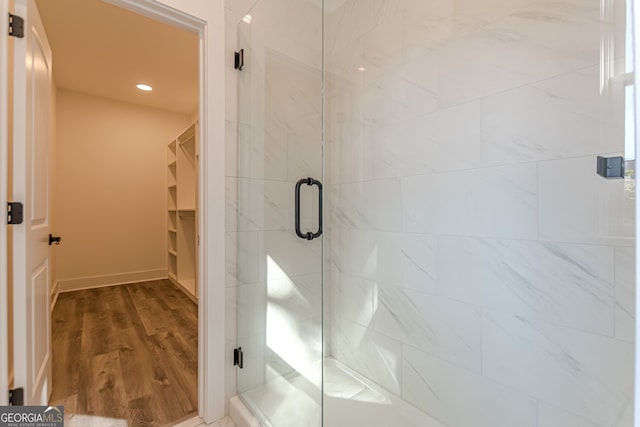 bathroom featuring hardwood / wood-style floors and an enclosed shower