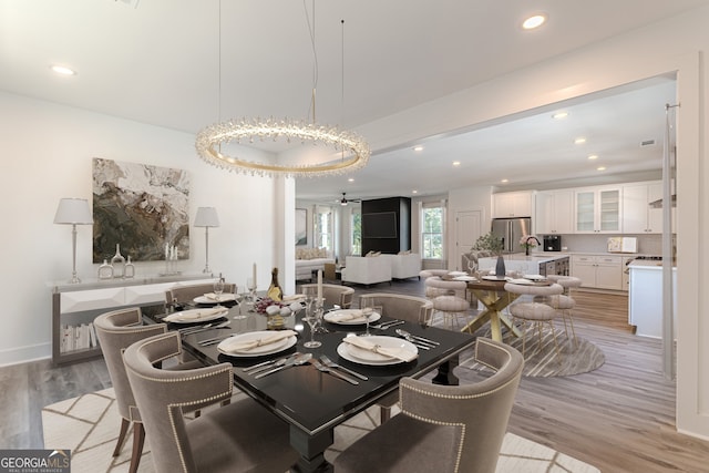 dining area featuring light hardwood / wood-style floors, sink, and ceiling fan