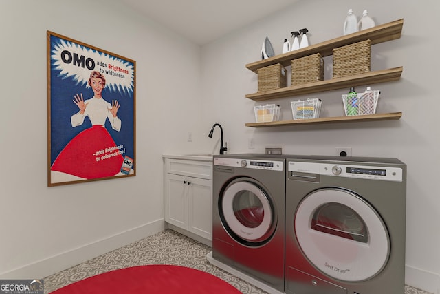 laundry area with sink, separate washer and dryer, and cabinets