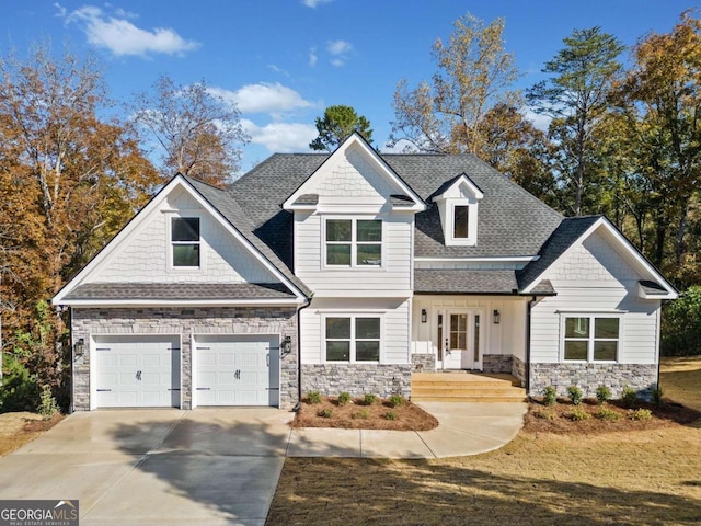 view of front of home with covered porch and a garage