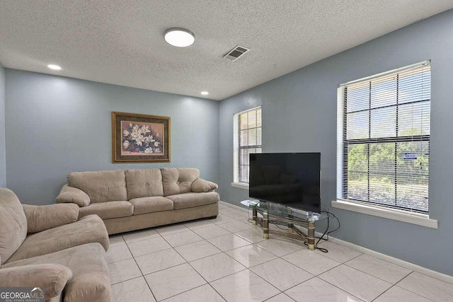 tiled living room with a textured ceiling