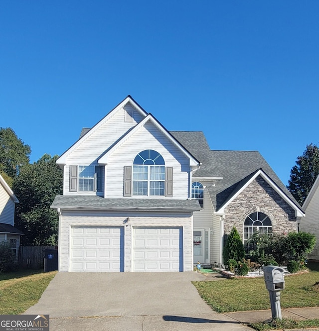 view of front property featuring a garage and a front lawn