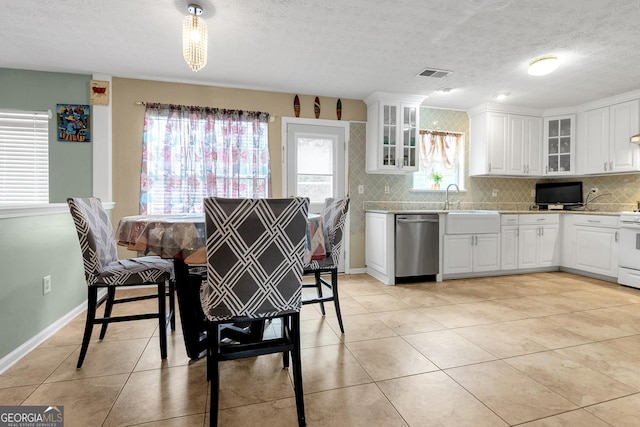 kitchen featuring white stove, white cabinetry, tasteful backsplash, stainless steel dishwasher, and light stone countertops