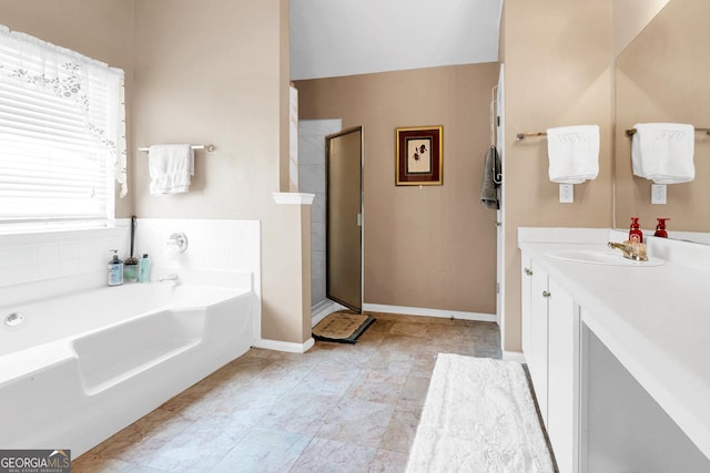 bathroom featuring vanity and separate shower and tub