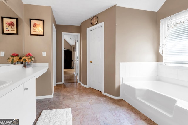 bathroom with vanity and a bath