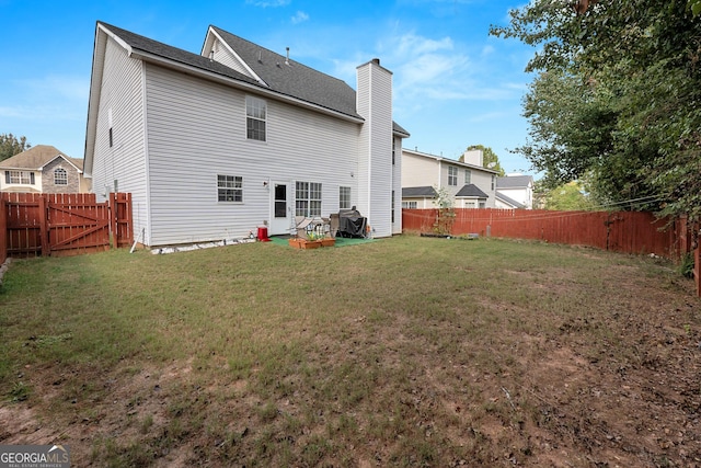 back of property with a lawn