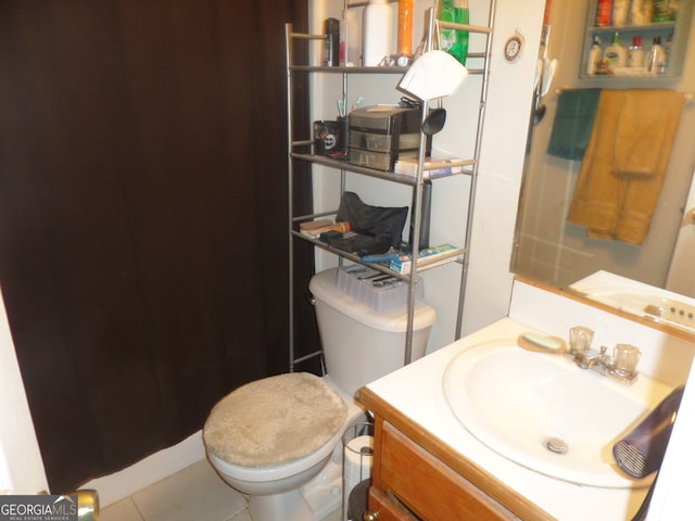 bathroom with vanity, toilet, and tile patterned floors