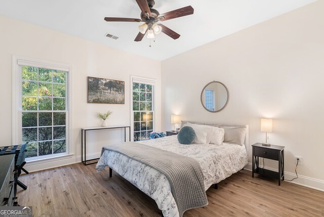 bedroom with ceiling fan and wood-type flooring