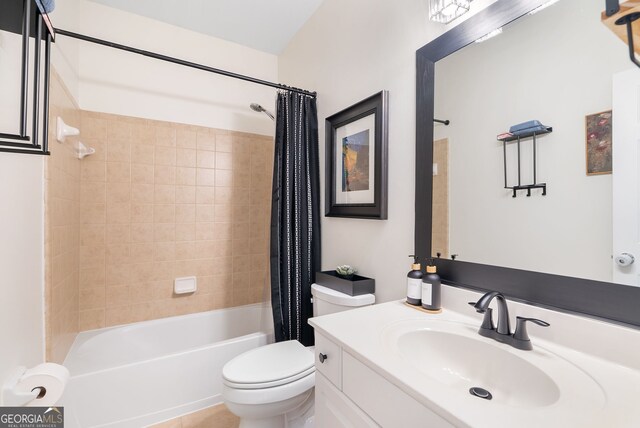 full bathroom featuring toilet, tile patterned floors, vanity, and shower / tub combo with curtain