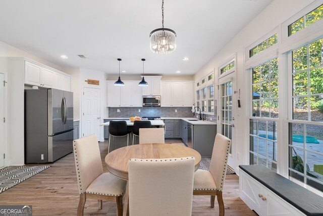 dining room with an inviting chandelier and light wood-type flooring