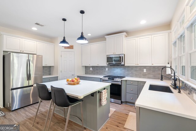 kitchen with a center island, white cabinets, and stainless steel appliances