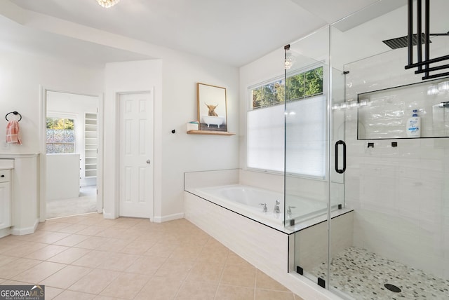 bathroom with tile patterned floors and independent shower and bath