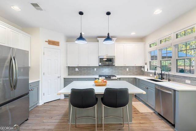 kitchen featuring white cabinets, sink, and appliances with stainless steel finishes