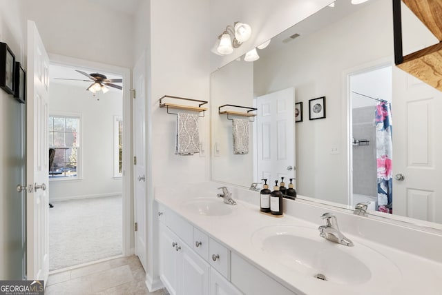 bathroom with tile patterned flooring, vanity, and ceiling fan