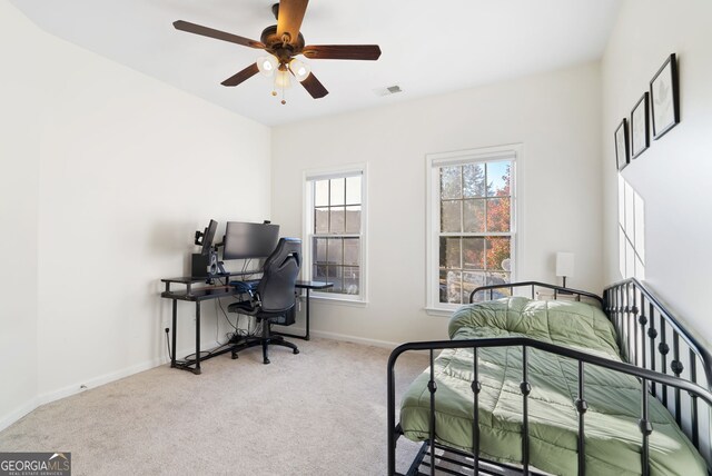 bedroom with ceiling fan and light colored carpet