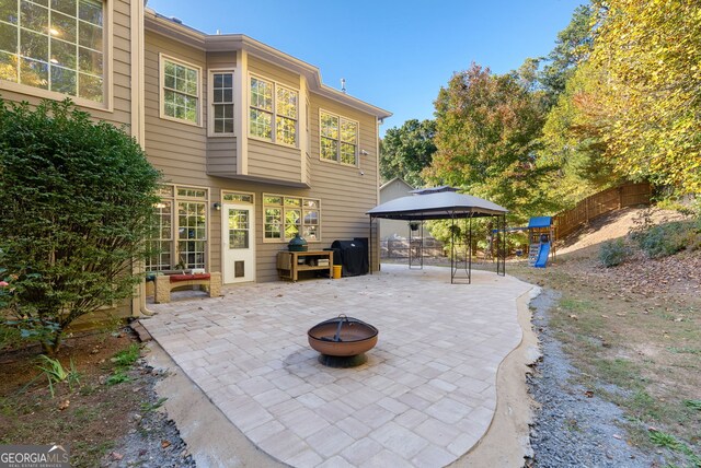 view of patio with a gazebo and a fire pit