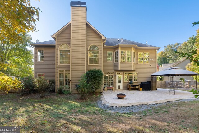 rear view of house featuring a gazebo and a patio