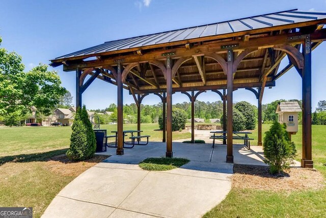 view of community featuring a lawn, a patio area, and a gazebo