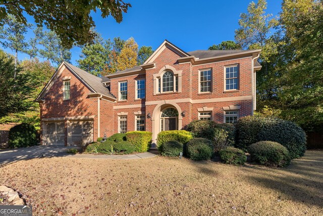 view of front of home with a front lawn and a garage