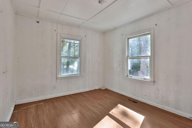 unfurnished room with hardwood / wood-style floors