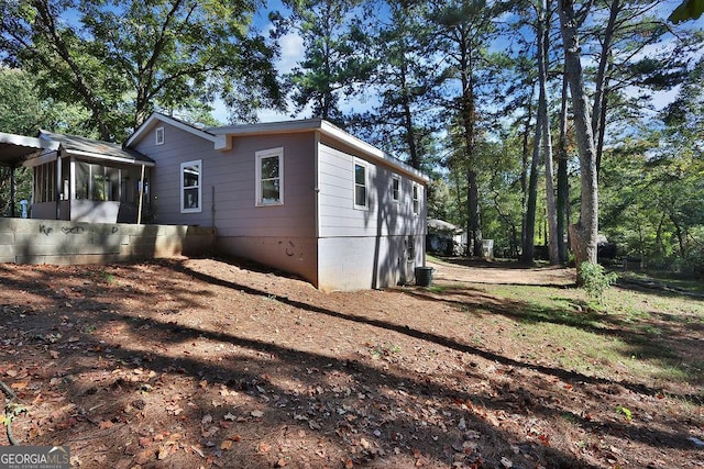 view of side of home with a sunroom