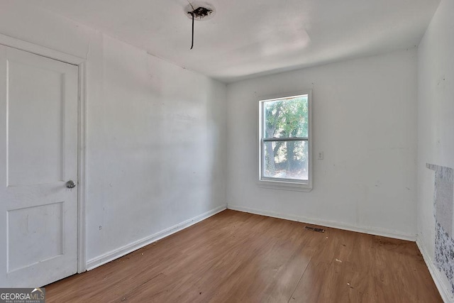 spare room featuring light wood-type flooring