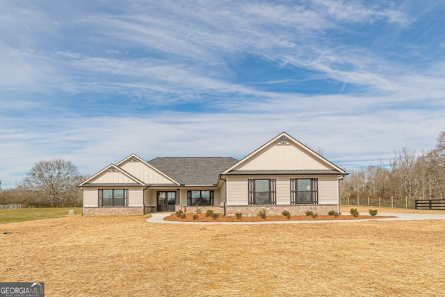 ranch-style home featuring a front yard