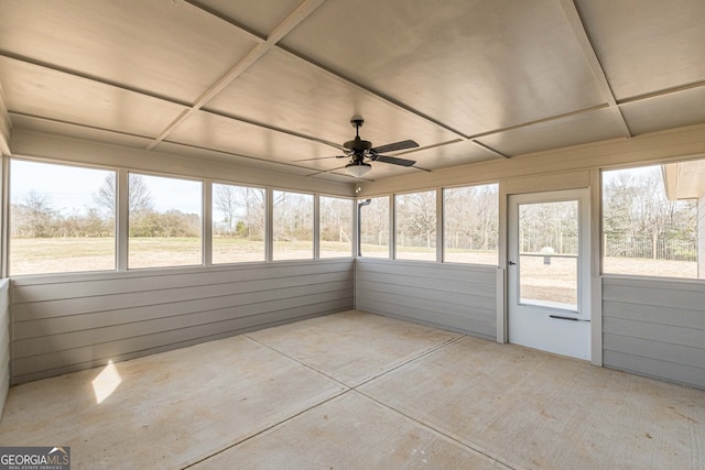 unfurnished sunroom with ceiling fan