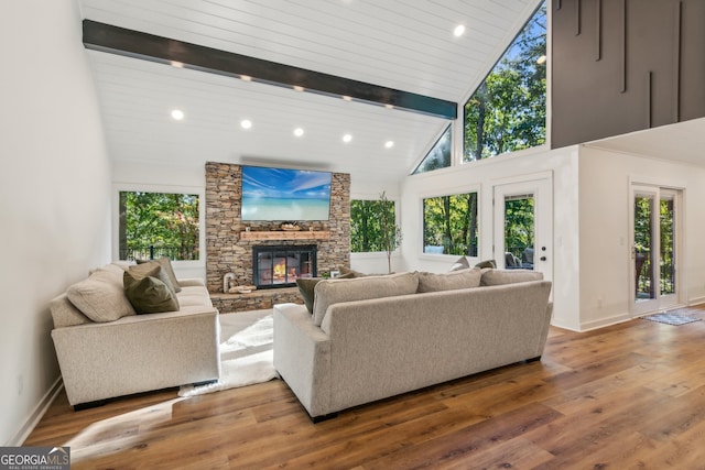 living room with beamed ceiling, high vaulted ceiling, a fireplace, wood-type flooring, and wood ceiling