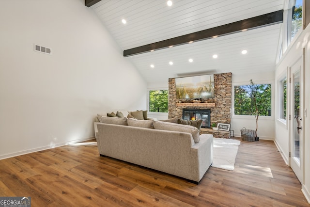 living room with high vaulted ceiling, wood-type flooring, and beam ceiling