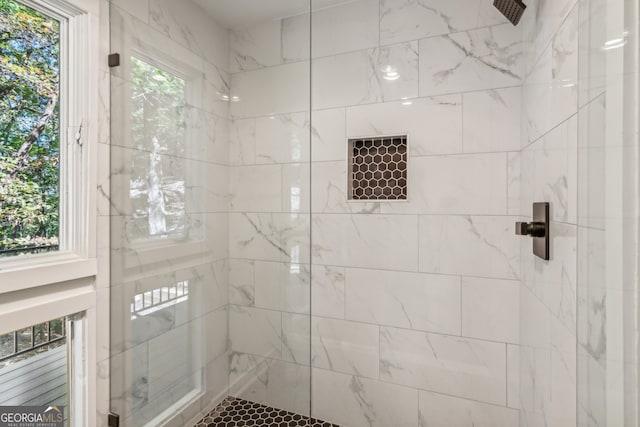 bathroom with plenty of natural light and a tile shower