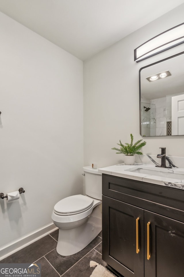 bathroom featuring tile patterned flooring, vanity, toilet, and a shower with door