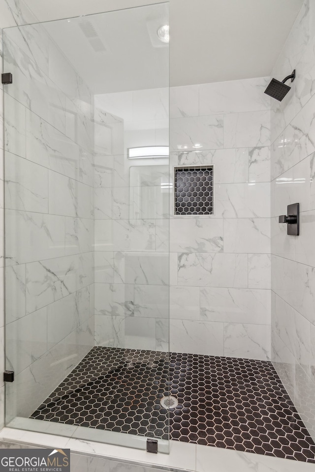 bathroom with a tile shower