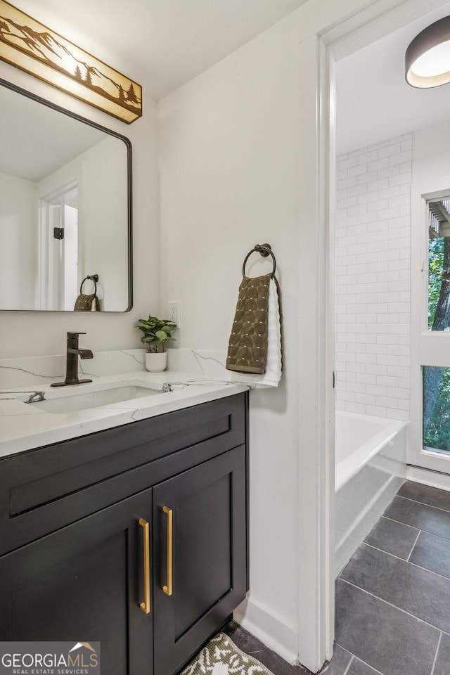 bathroom featuring vanity, tile patterned floors, and tiled shower / bath