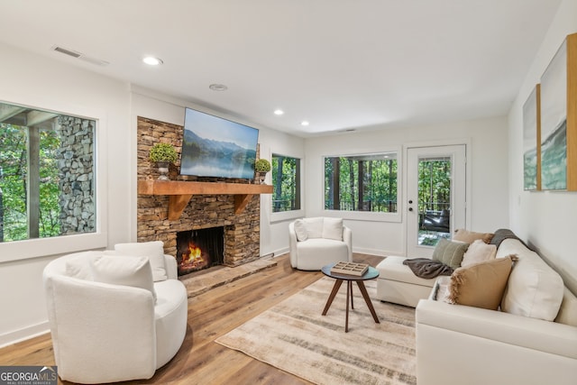 living room featuring light hardwood / wood-style floors and a fireplace