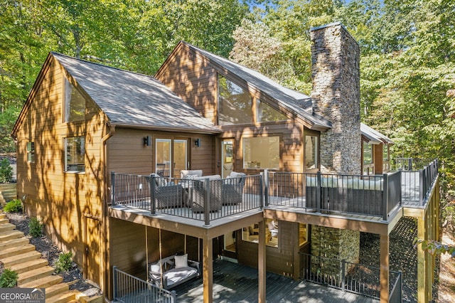 back of property featuring a wooden deck