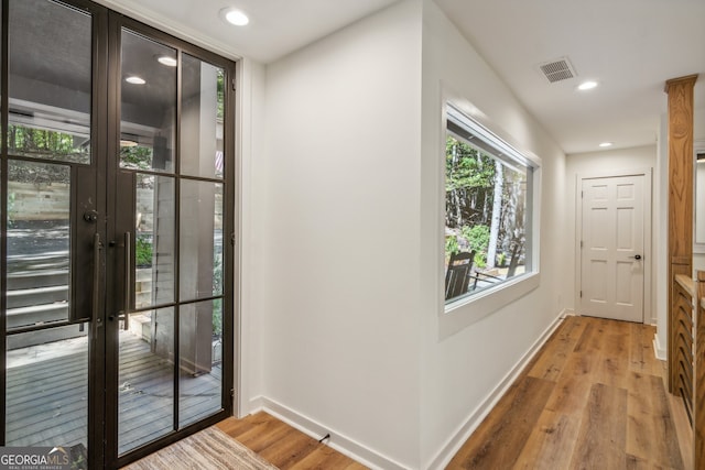 entryway featuring french doors and light hardwood / wood-style floors