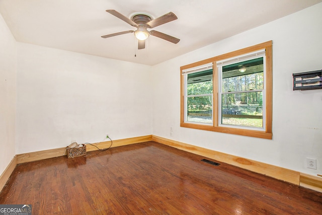 spare room featuring dark hardwood / wood-style flooring and ceiling fan