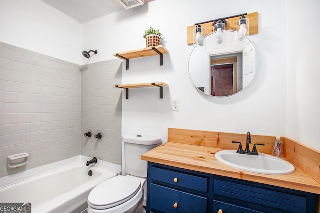 full bathroom with tiled shower / bath combo, toilet, and vanity