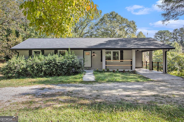 view of front of home featuring covered porch and a carport