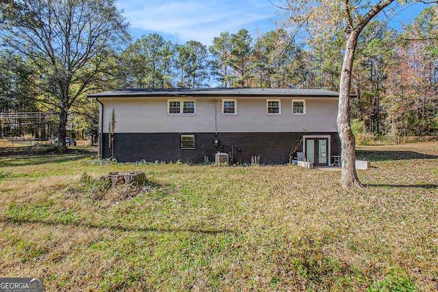 back of house featuring french doors, a yard, and central AC