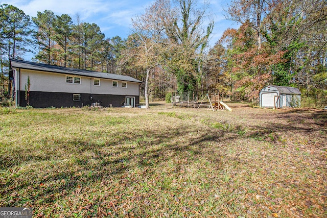 view of yard with a playground and a shed