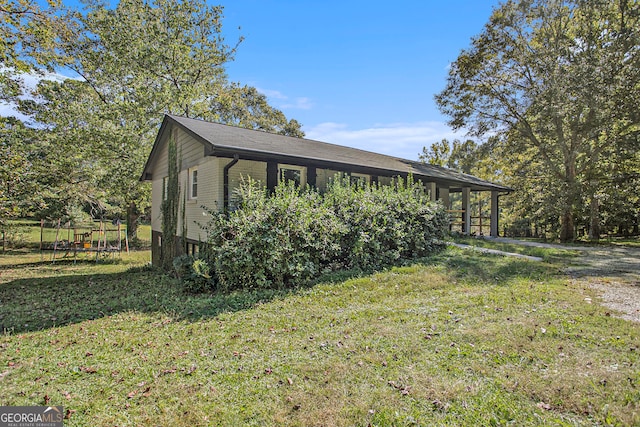 view of side of property with a yard