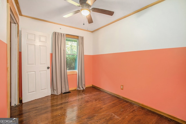 spare room featuring dark hardwood / wood-style floors, ceiling fan, and ornamental molding